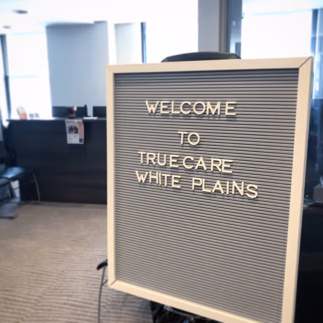 Interior reception lobby with a sign reading Welcome to True Care White Plains