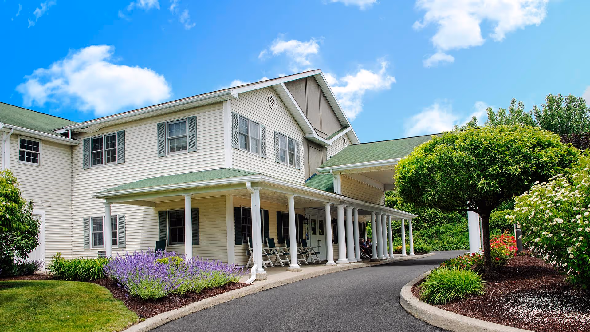 Exterior of Peregrine Senior Living at Shaker with a covered porch and landscaped grounds