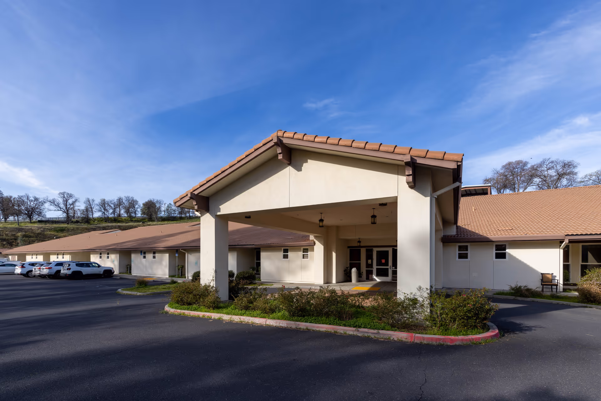 Front exterior of a single-story senior care center with a covered entrance.