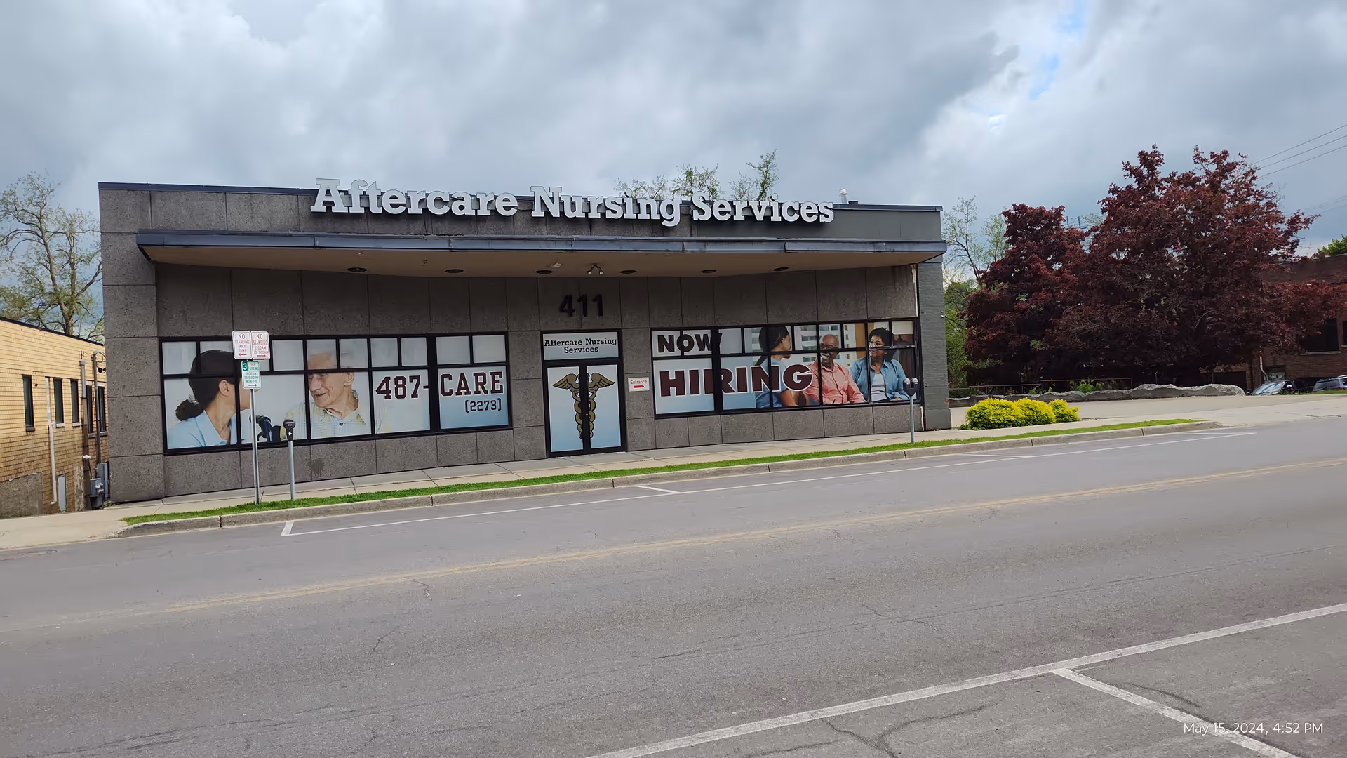 Exterior view of Aftercare Nursing Services building with large sign and front windows.