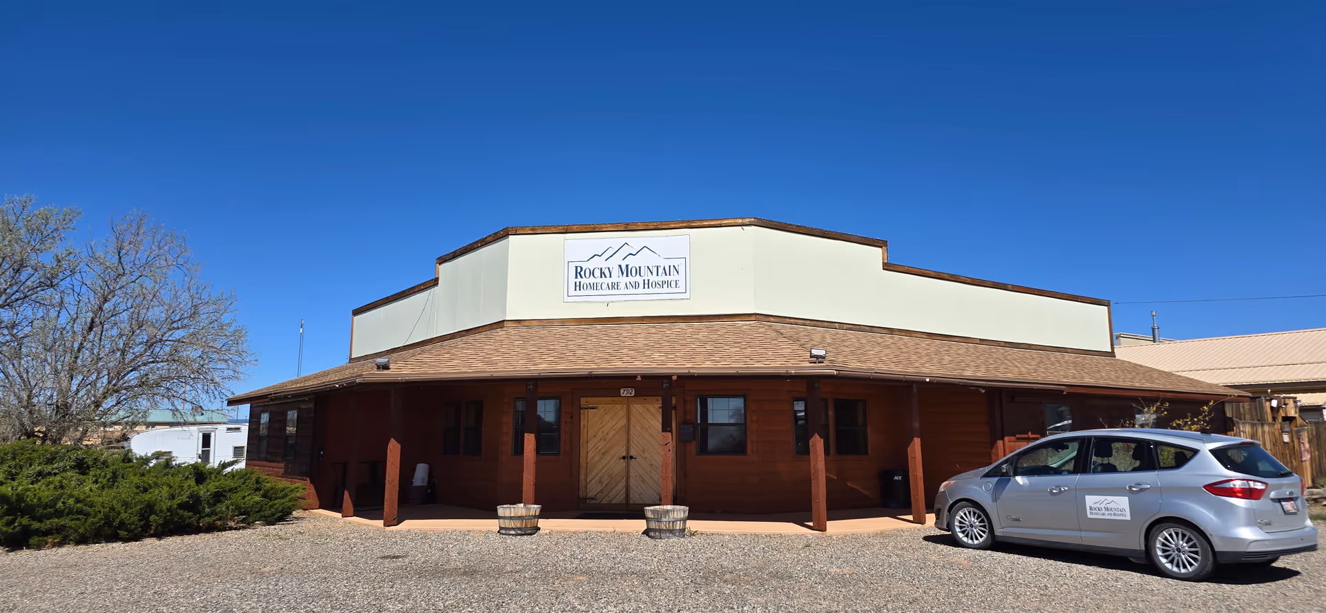Front view of Rocky Mountain Home Care & Hospice building with a parked silver car.
