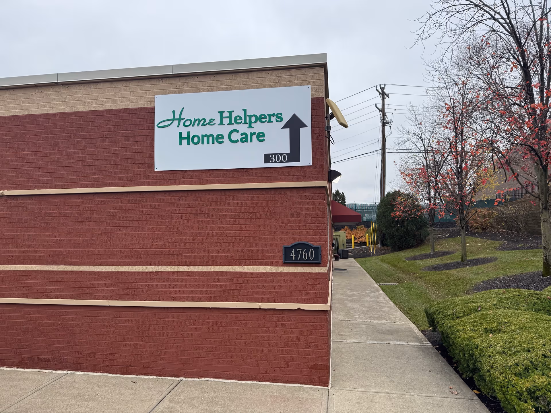 Exterior view of a brick building with a Home Helpers Home Care sign.