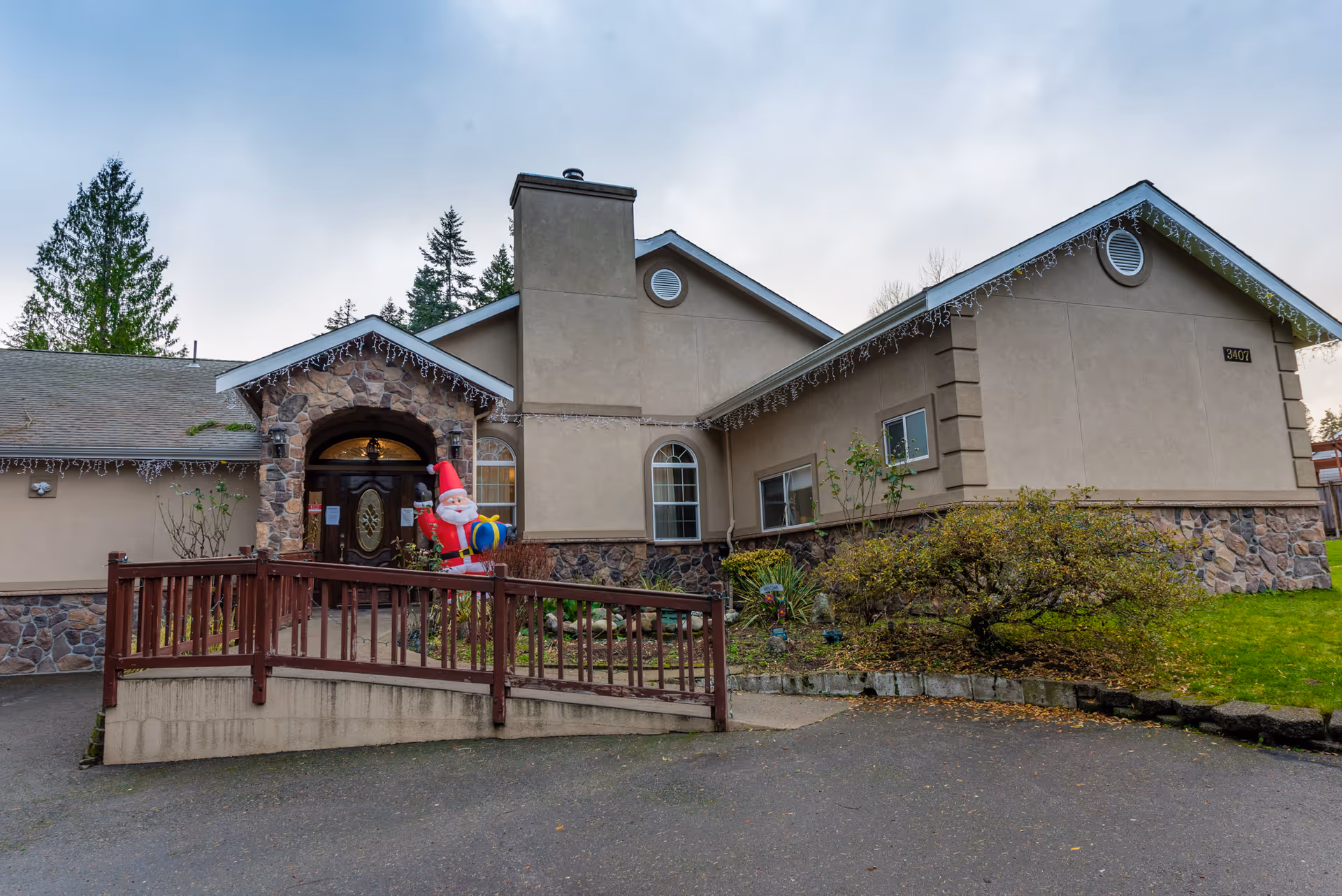 Front view of Pine Lake AFH facility with a wheelchair ramp and festive decoration.
