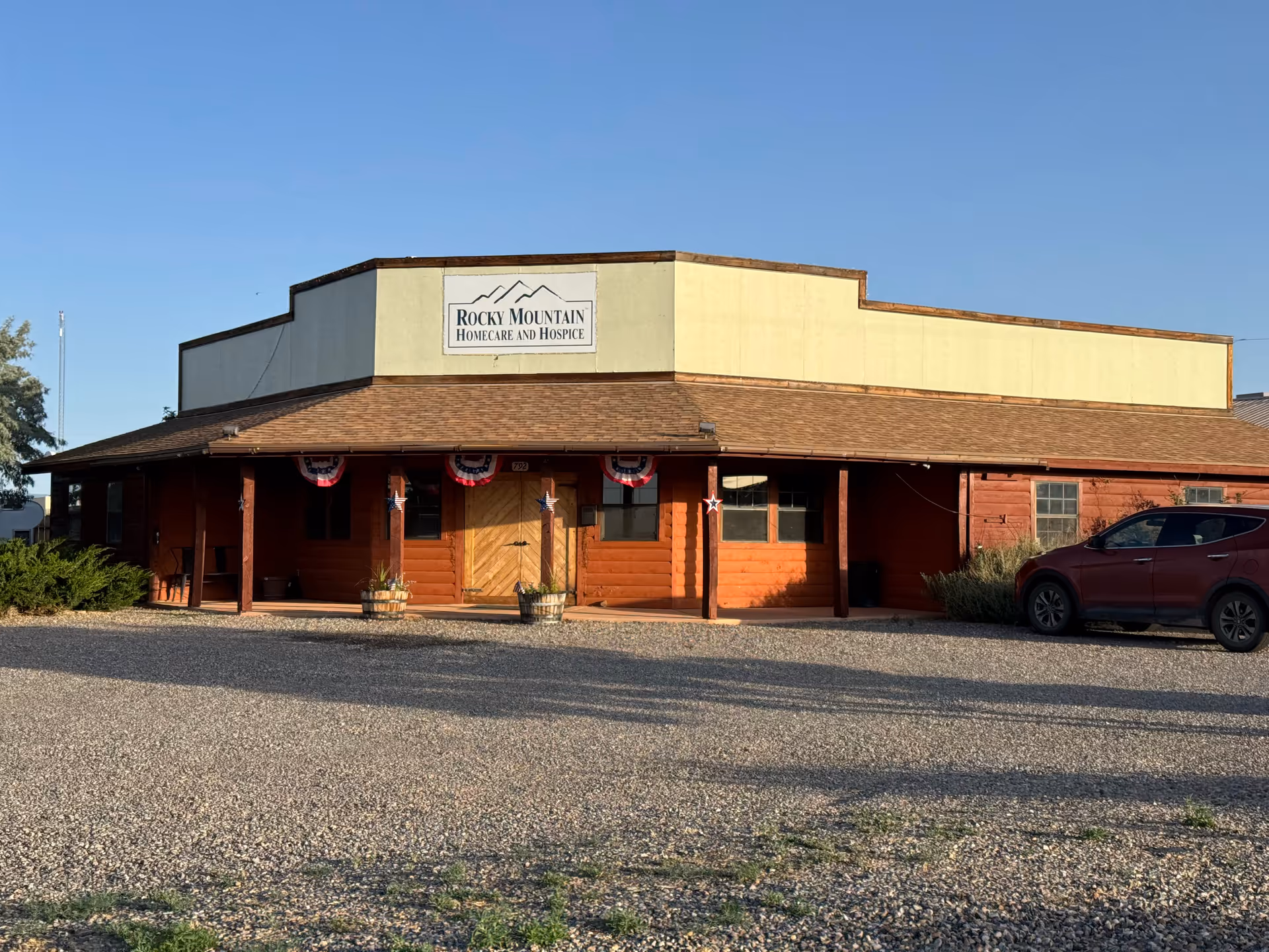 A single-story building labeled Rocky Mountain Homecare and Hospice with a gravel parking area.