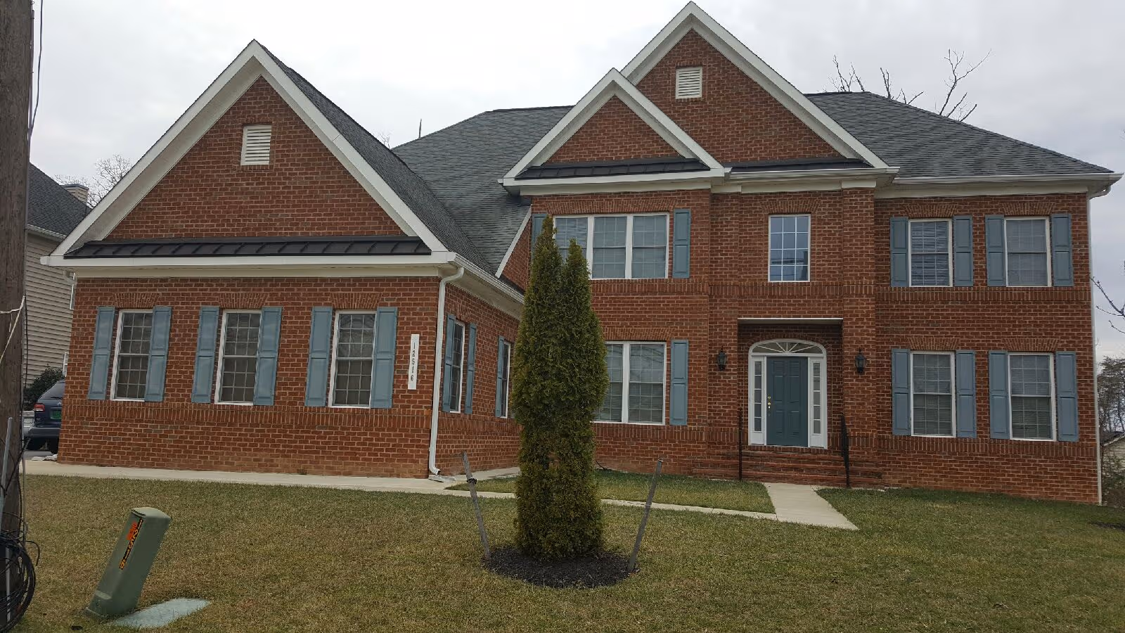 Exterior view of a brick senior living facility with a front entrance.