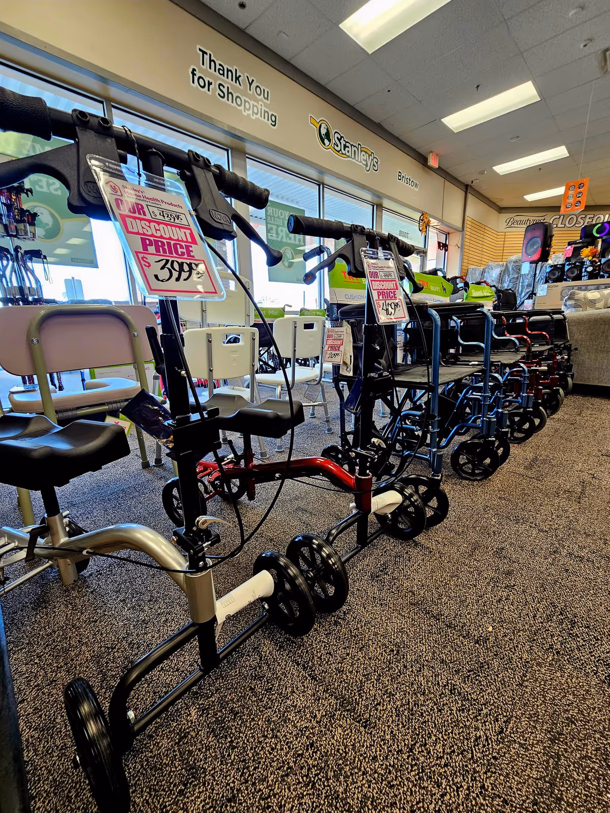 Row of mobility devices and walkers displayed inside Stanley's Home Health Products & Mobility Center showroom.