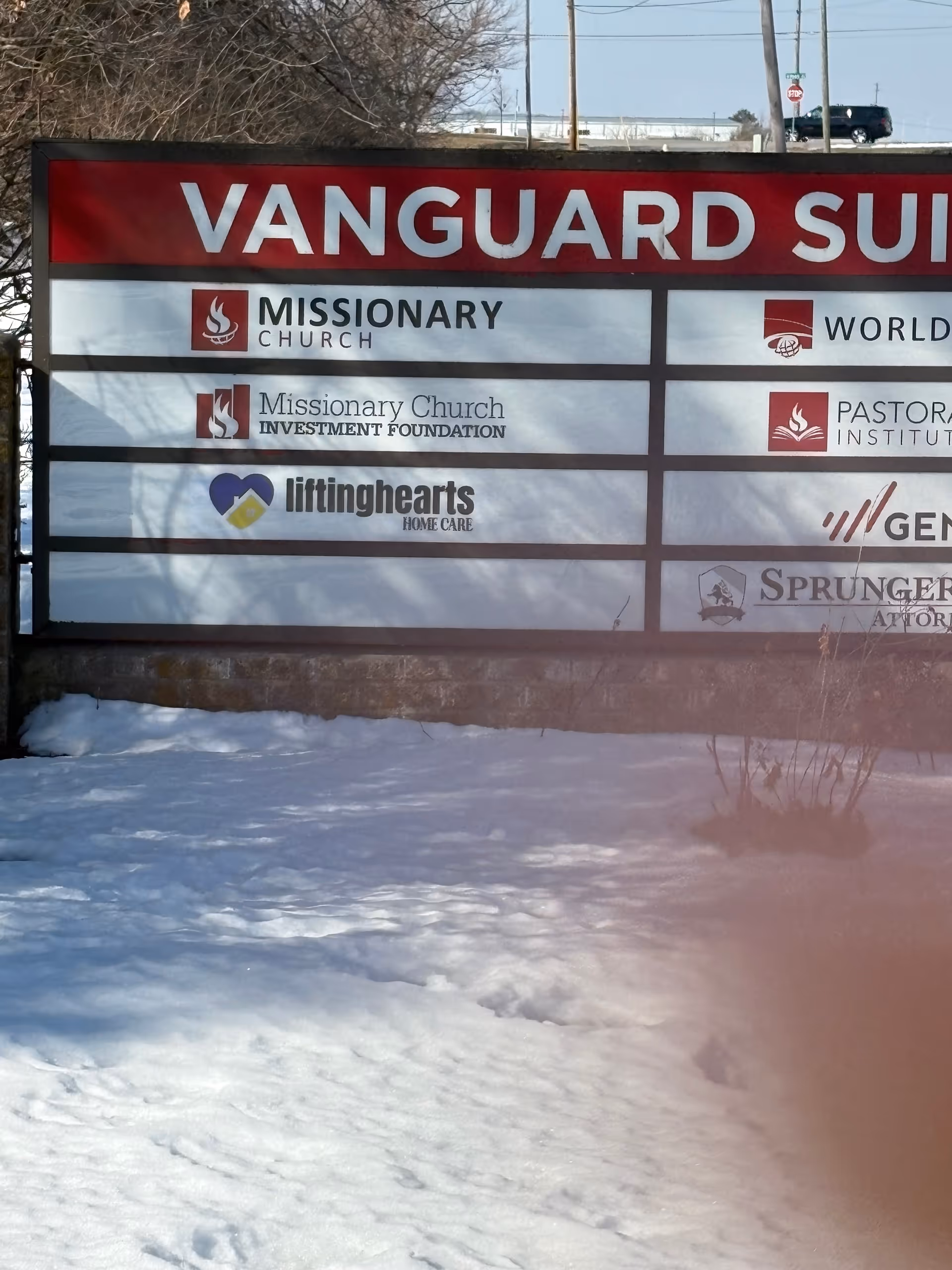 Outdoor signboard displaying Lifting Hearts Home Care among other logos.