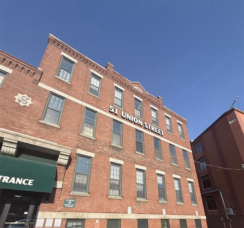 Brick building with '51 Union Street' sign and green entrance canopy.