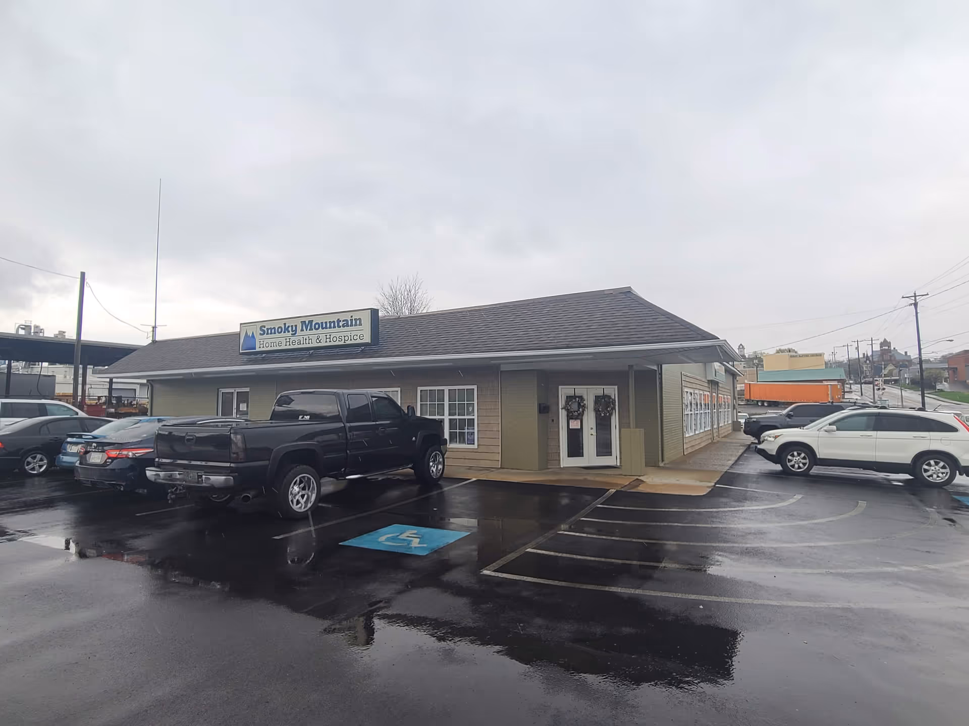 Front view of Smoky Mountain Home Health & Hospice building with parked cars in lot