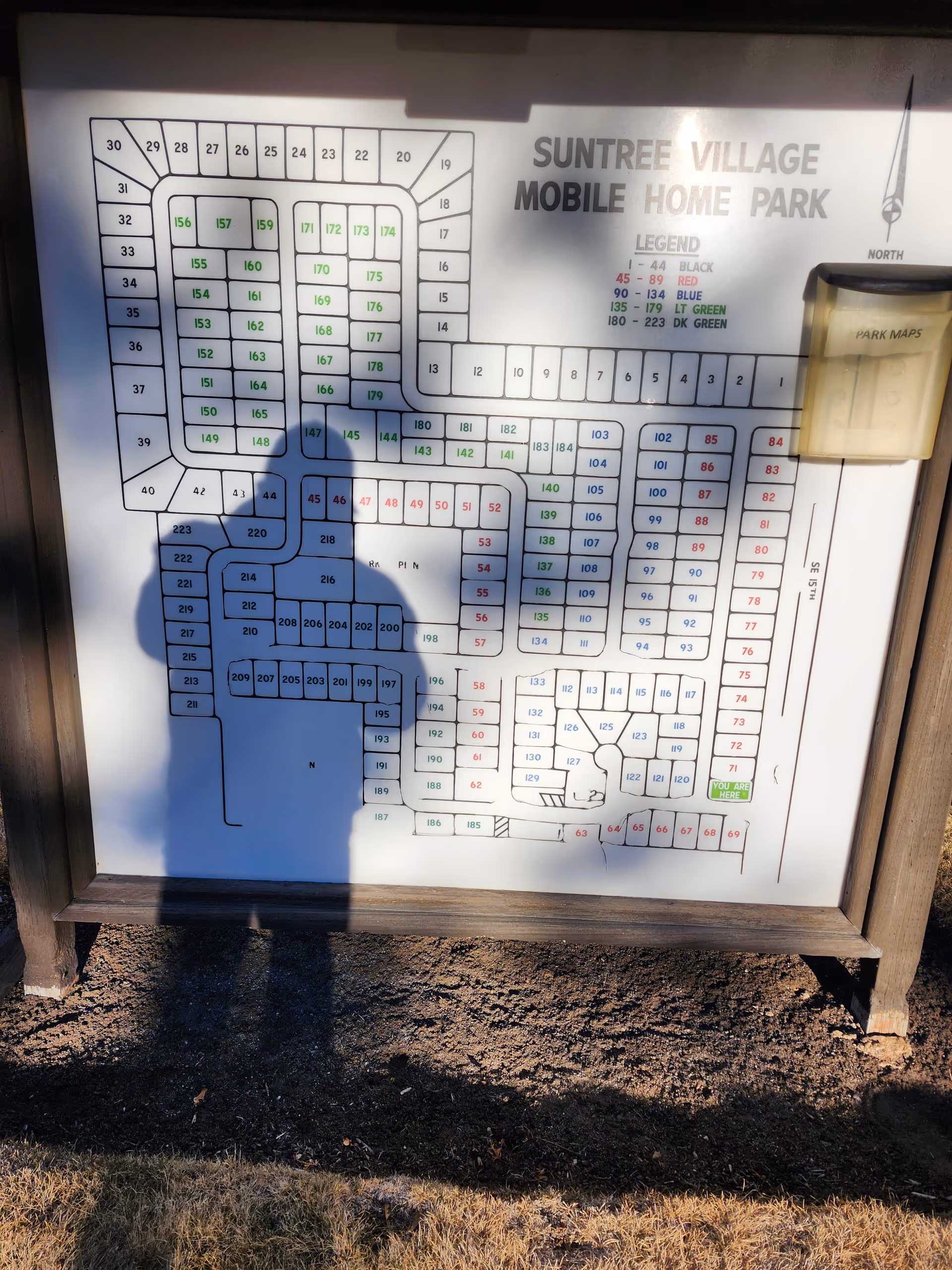Outdoor signboard displaying a detailed map layout of Suntree Village Mobile Home Park.