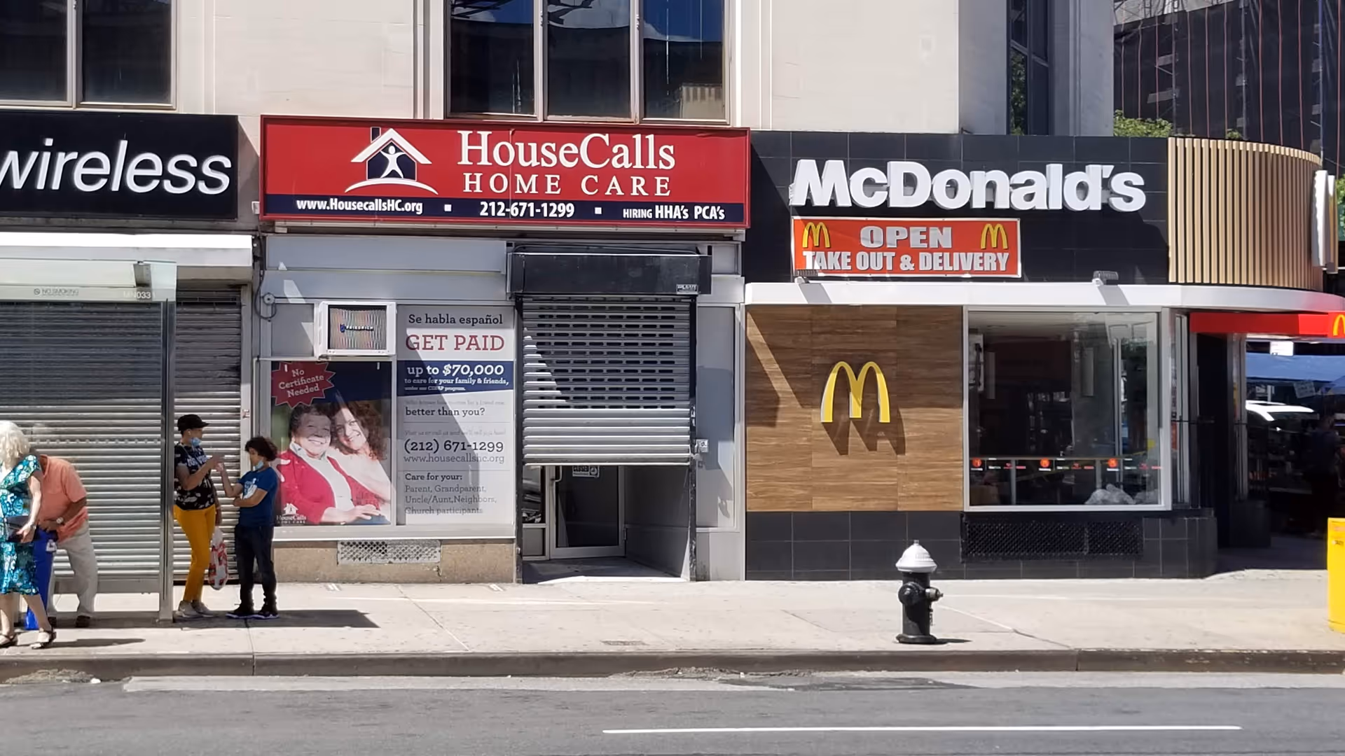 Storefronts along a city sidewalk, featuring House Calls Home Care sign next to McDonald's.
