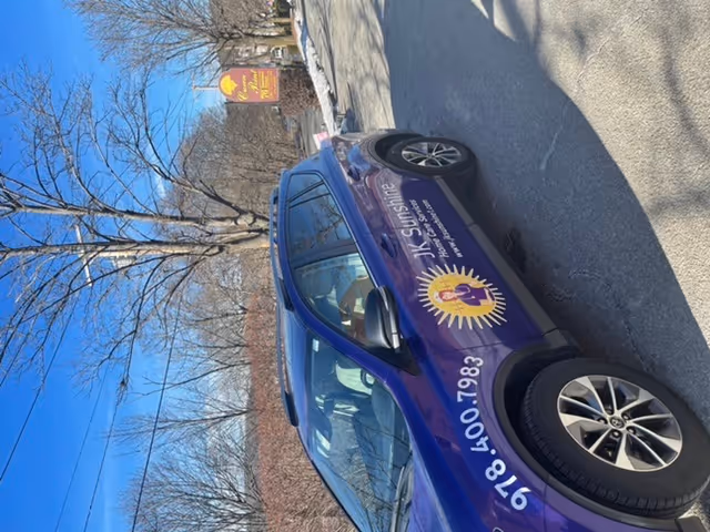 Purple service vehicle branded JK Sunshine Home Care Services parked on a street.