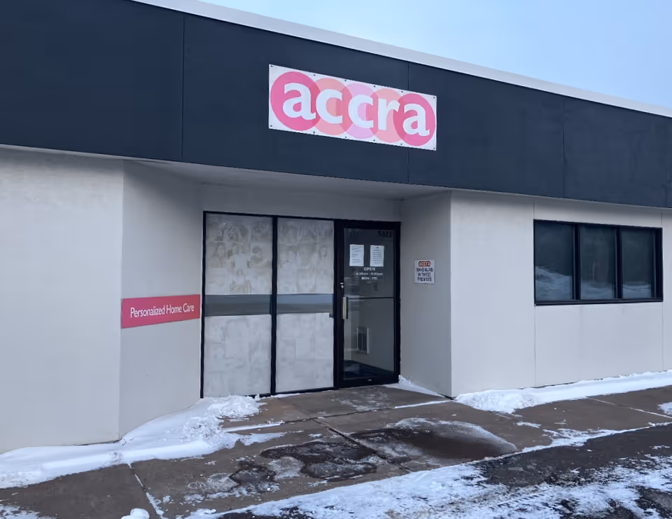 Exterior of an Accra Home Care building with a pink Accra sign above entrance.