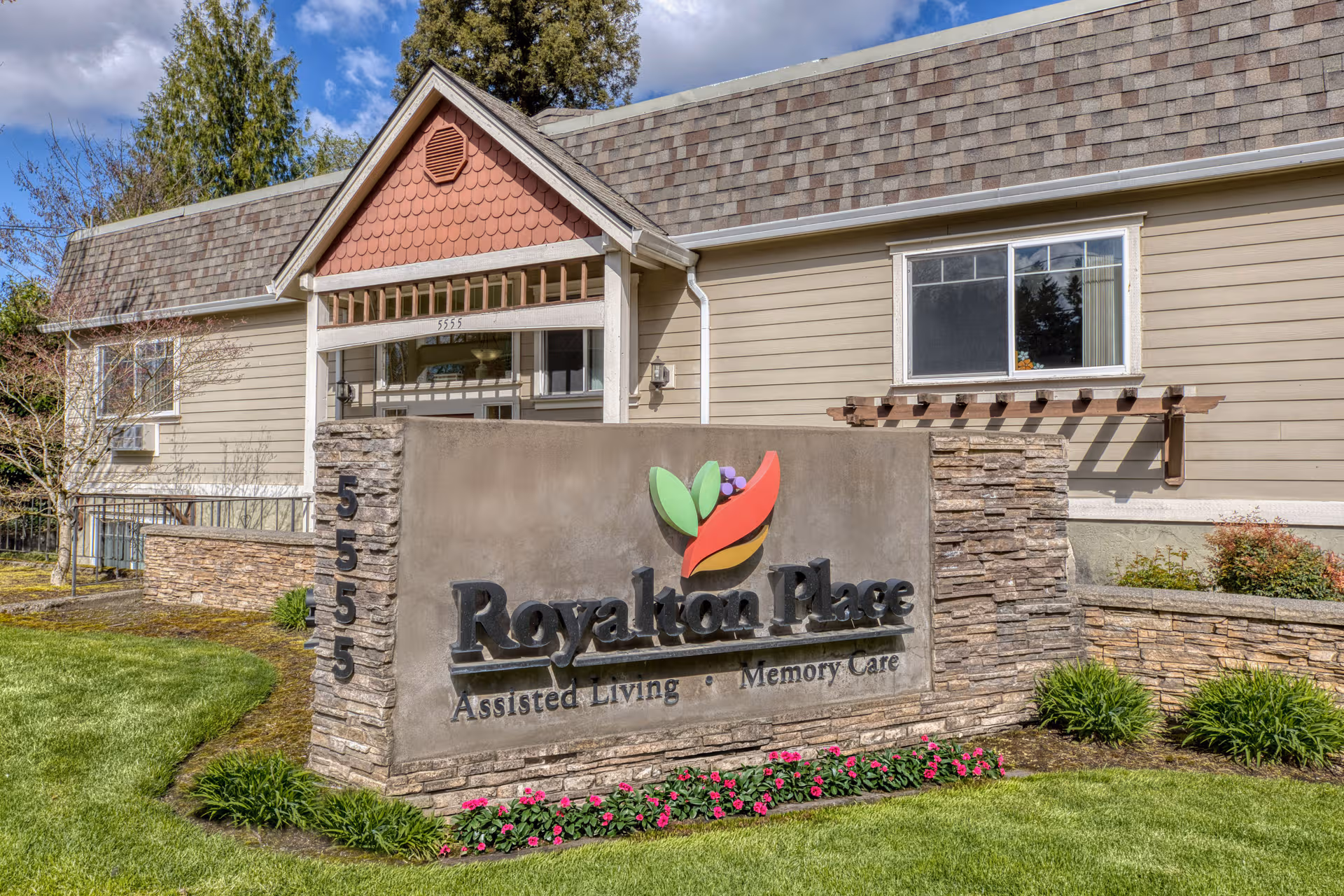 Front exterior of Royalton Place senior living with a stone sign.