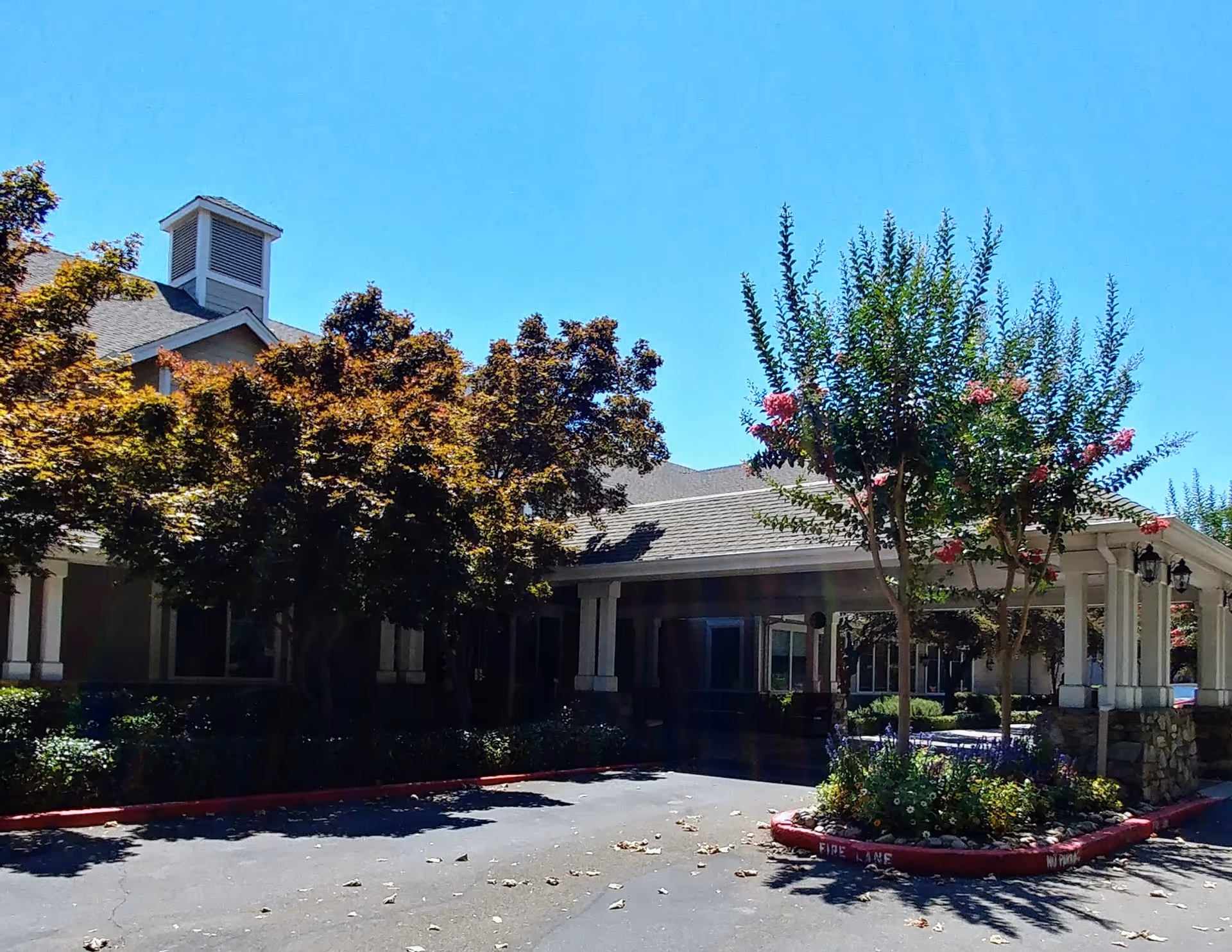 Exterior view of Oakmont of Brookside with a covered entrance and landscaping.