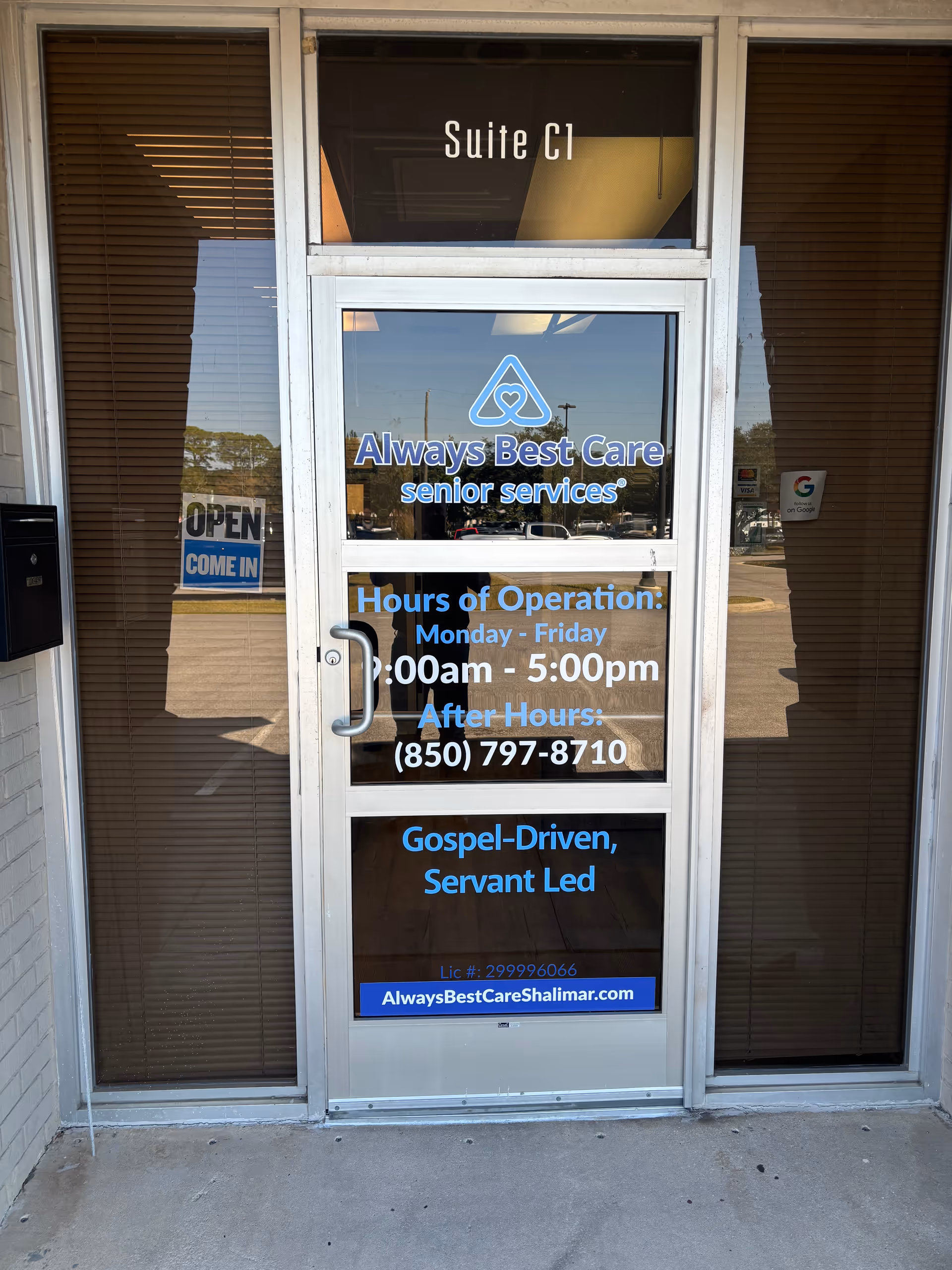 Glass storefront door displaying Always Best Care Senior Services signage and hours.