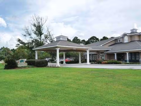 Garden View Assisted Living exterior with a covered entrance and green lawn.