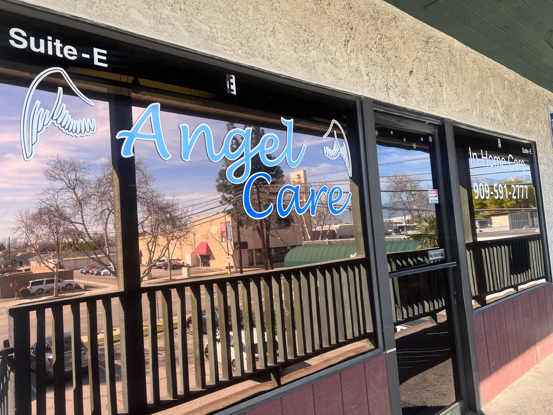Exterior storefront displaying Angel Care signage and wing graphics on glass windows.