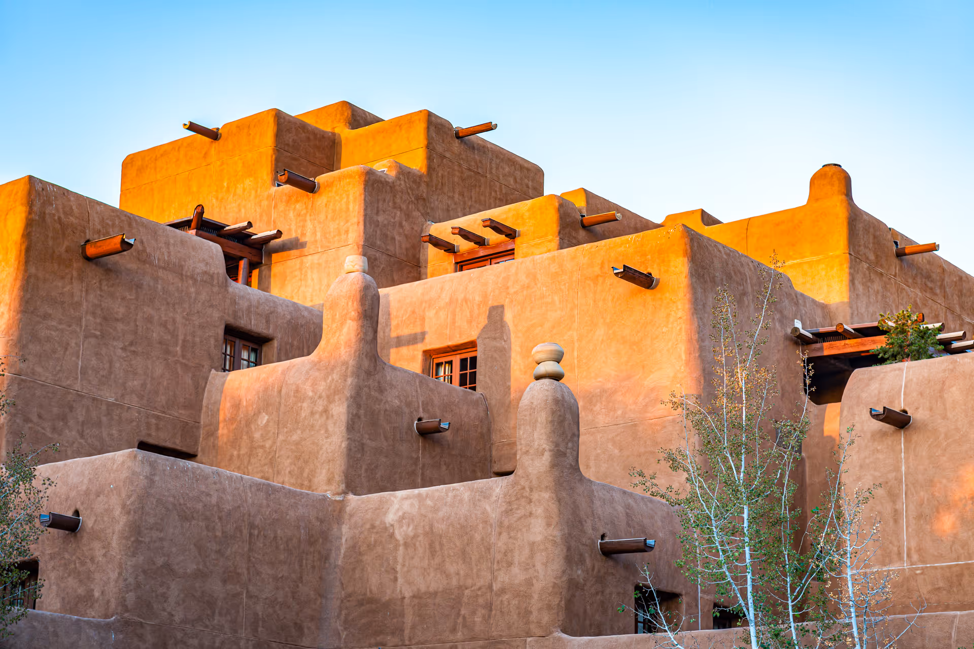 Adobe-style southwestern healthcare facility exterior with stucco walls and towers.