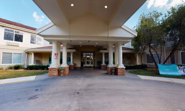 Front entrance of The Springs at Lady Lake Assisted Living with a covered drop-off