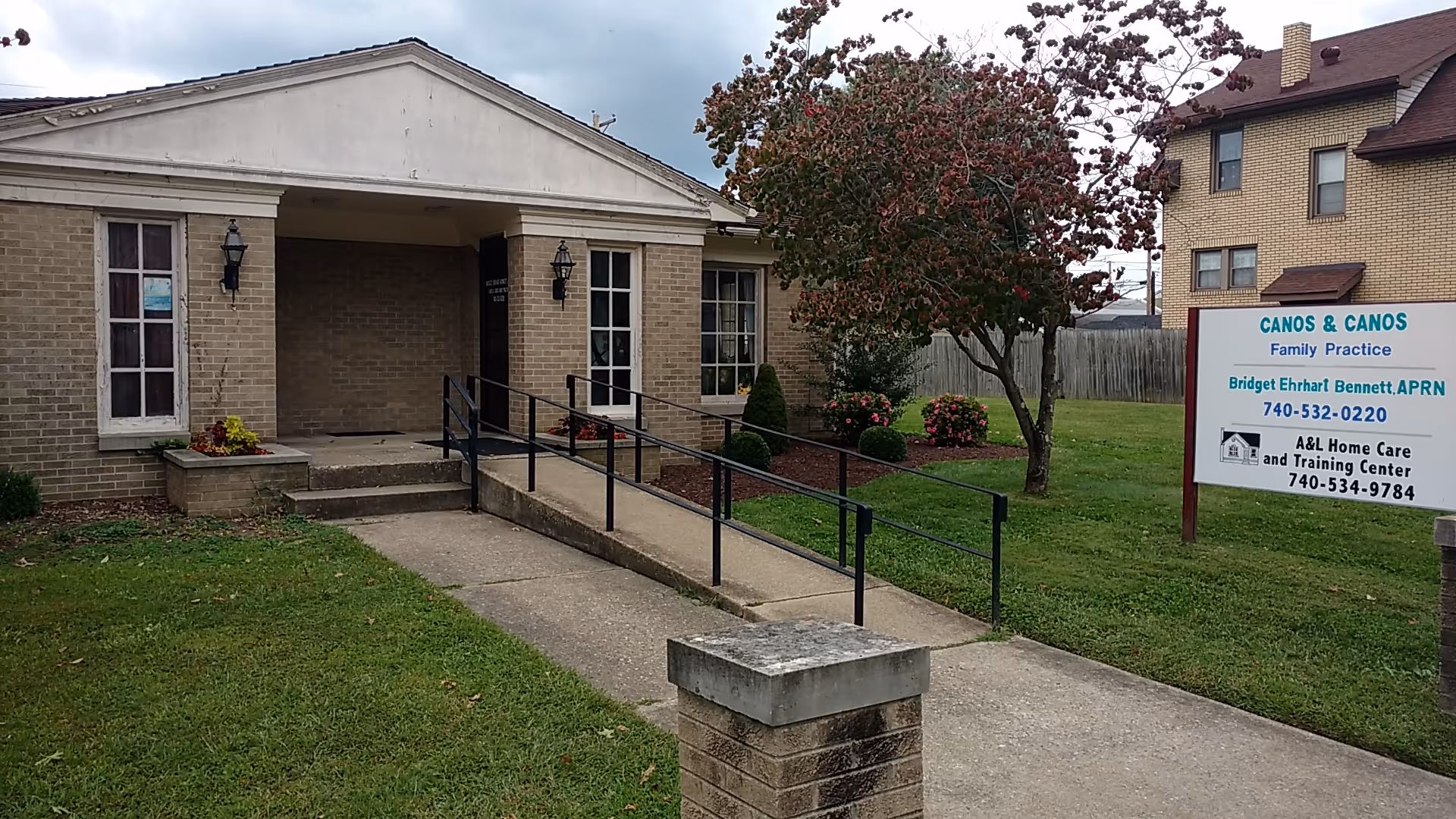 Front entrance of A&L Home Care and Training Center with ramp and sign.