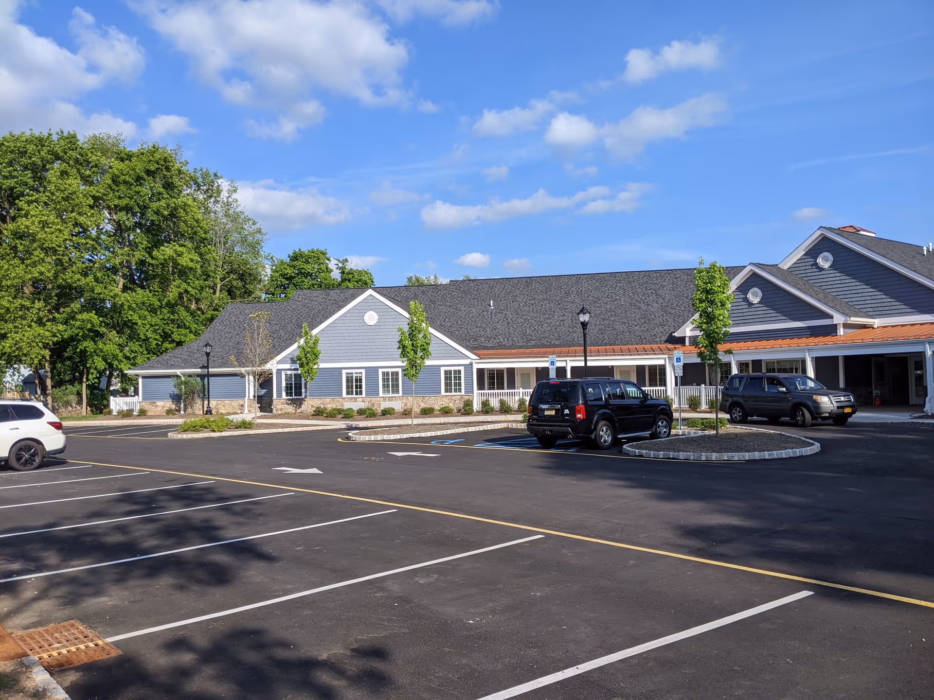 Graceland Gardens Assisted Living facility exterior with parking lot and blue siding.
