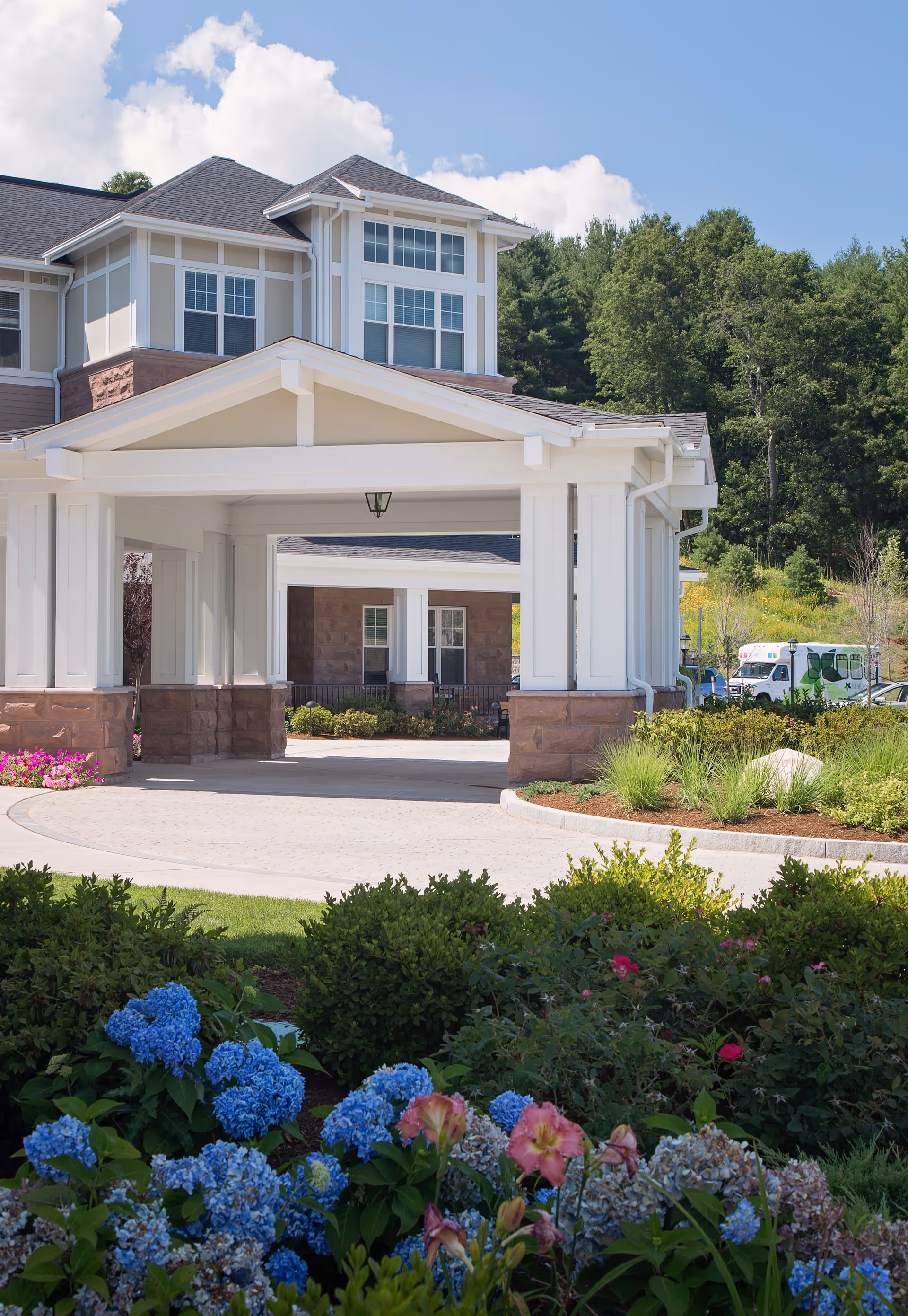 Front view of The Residence at Brookside, a senior living facility, with covered entrance.