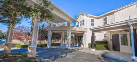 Front exterior of Brookdale Folsom senior living facility with covered entrance and drive.