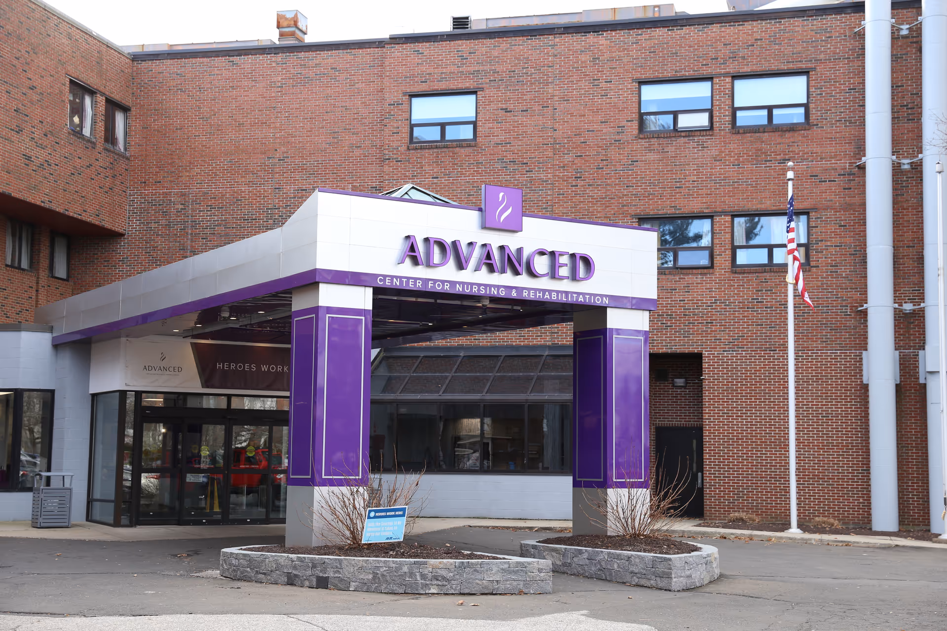 Exterior view of Advanced Center for Nursing and Rehabilitation entrance with purple pillars.