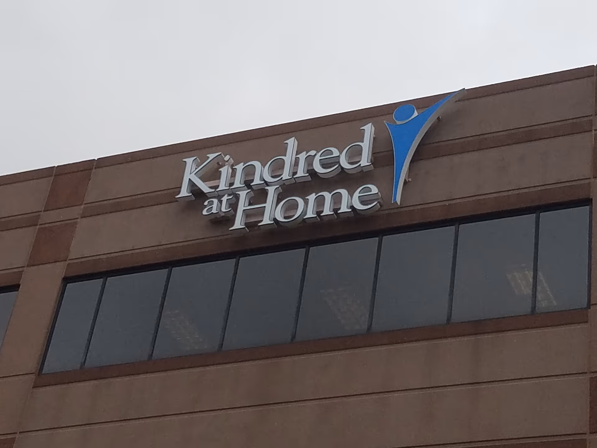 Exterior view of a Kindred at Home facility with a large front sign.