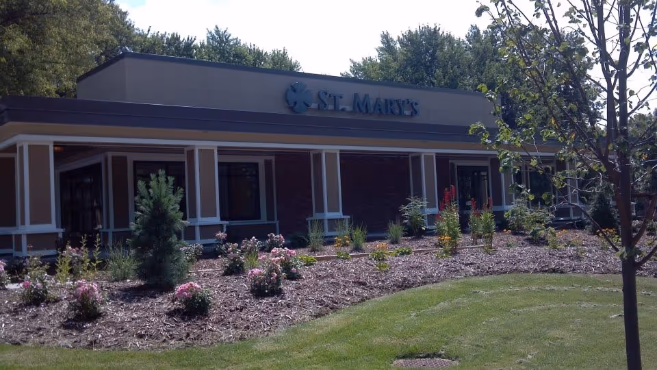 Exterior view of a Benedictine Living Community facility with landscaped front yard.