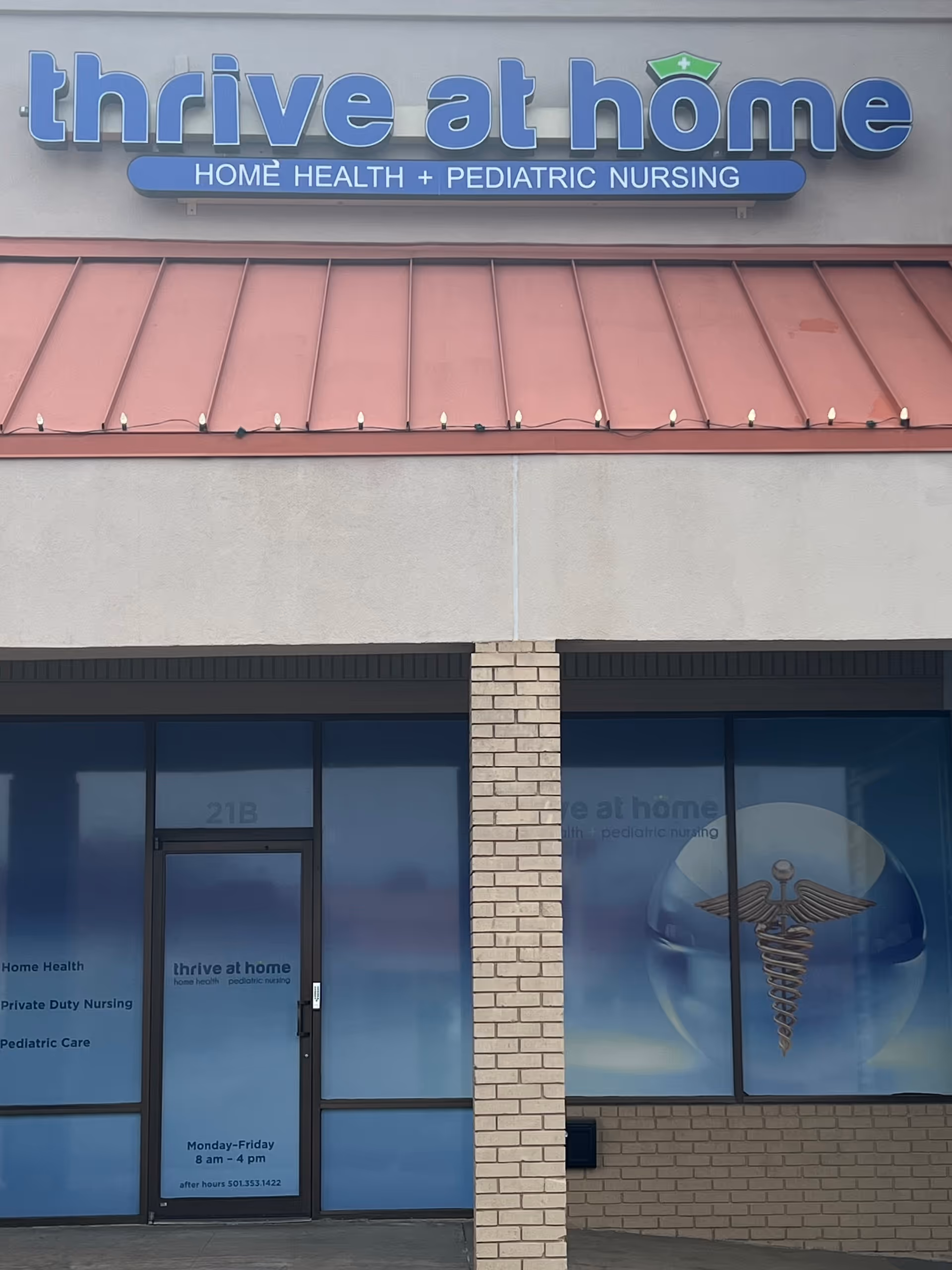 Exterior storefront for Thrive at Home Pediatric Nursing, showing the sign and logo.