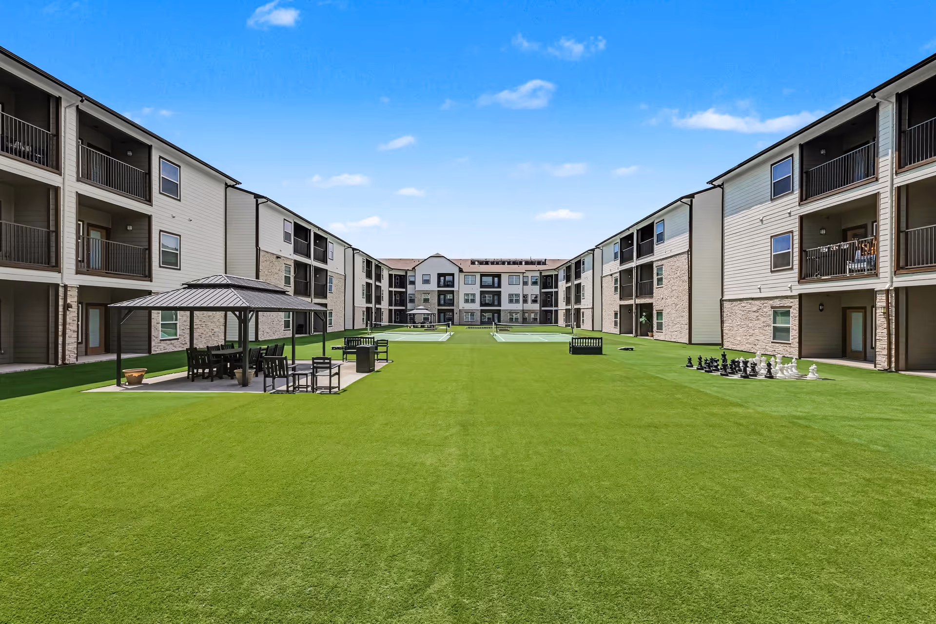 Park Residences Plano outdoor courtyard between apartment buildings with seating and gazebo.