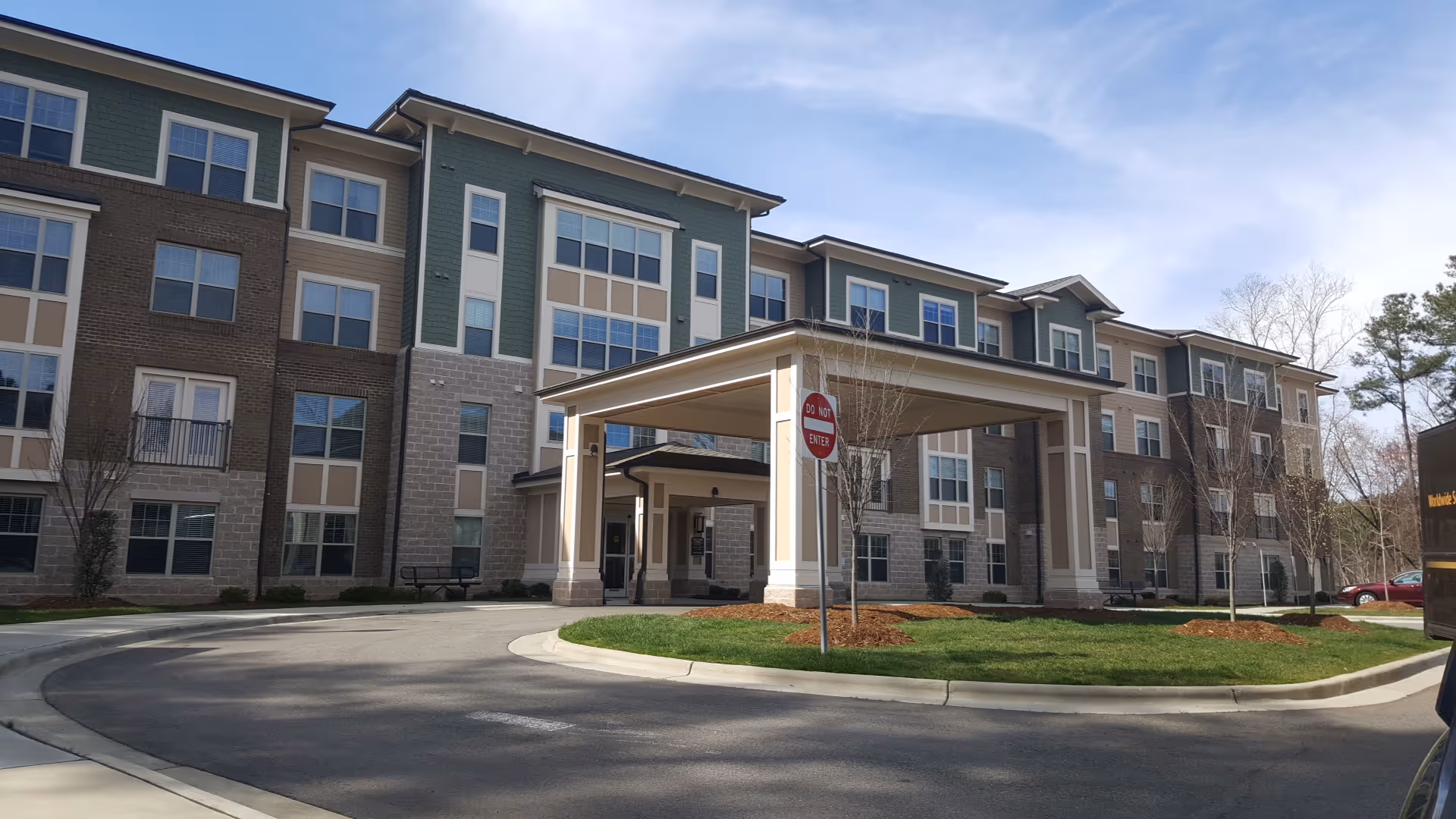 Exterior view of Willow Creek Senior Living Apartments with a covered entrance.