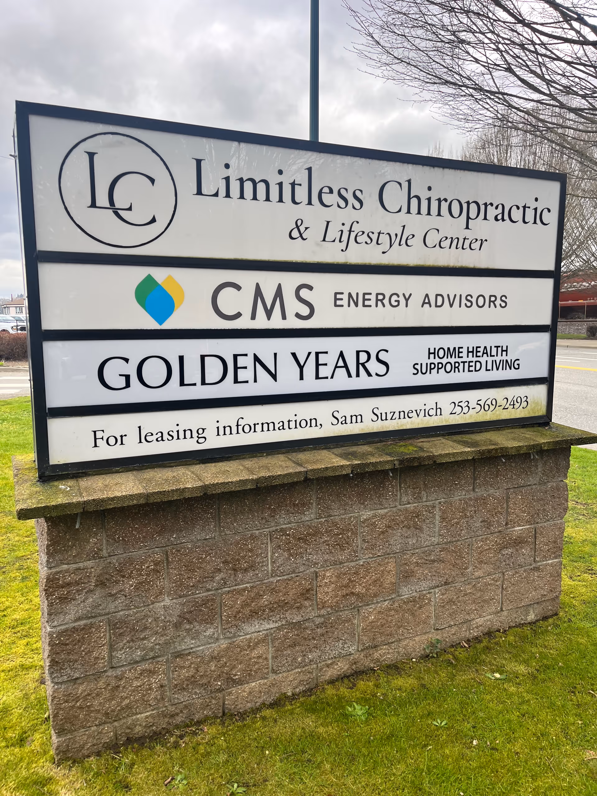 Outdoor sign on a brick base listing Golden Years Home Health and others.