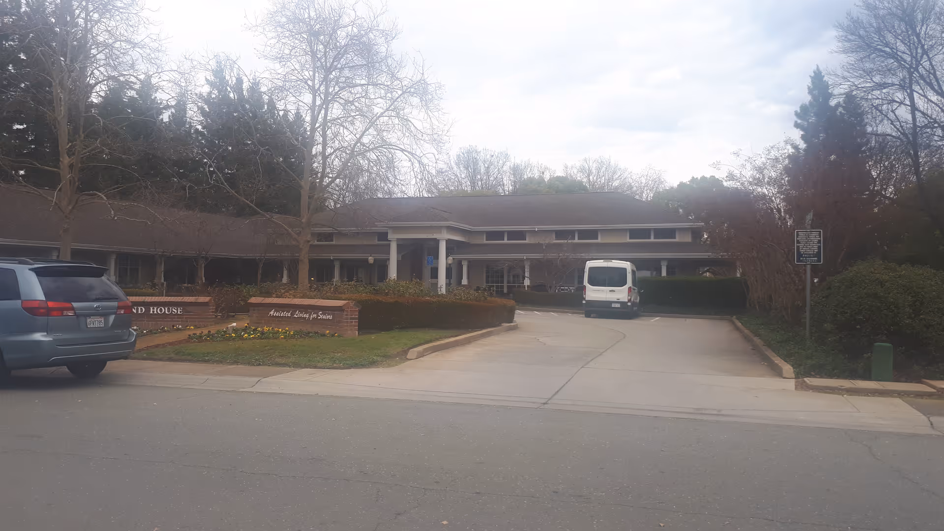 Townsend House senior living facility exterior with driveway, signage, and a white van.