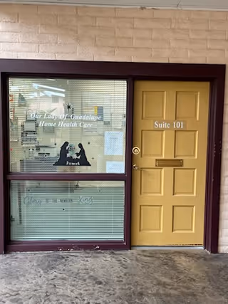Exterior entrance of Our Lady of Guadalupe Home Health Care with a yellow Suite 101 door.