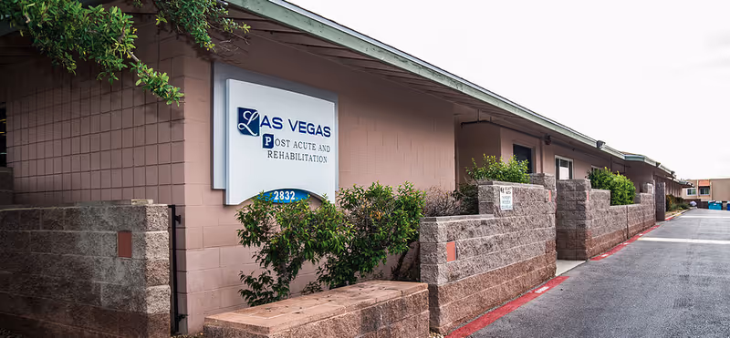 Exterior of Las Vegas Post Acute and Rehabilitation building with sign and landscaping.