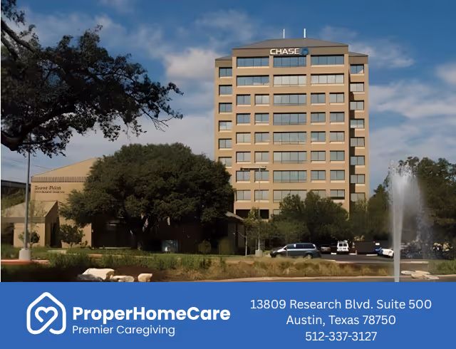 Tall, multi-story office building with trees, fountain, and a blue Proper Home Care banner.