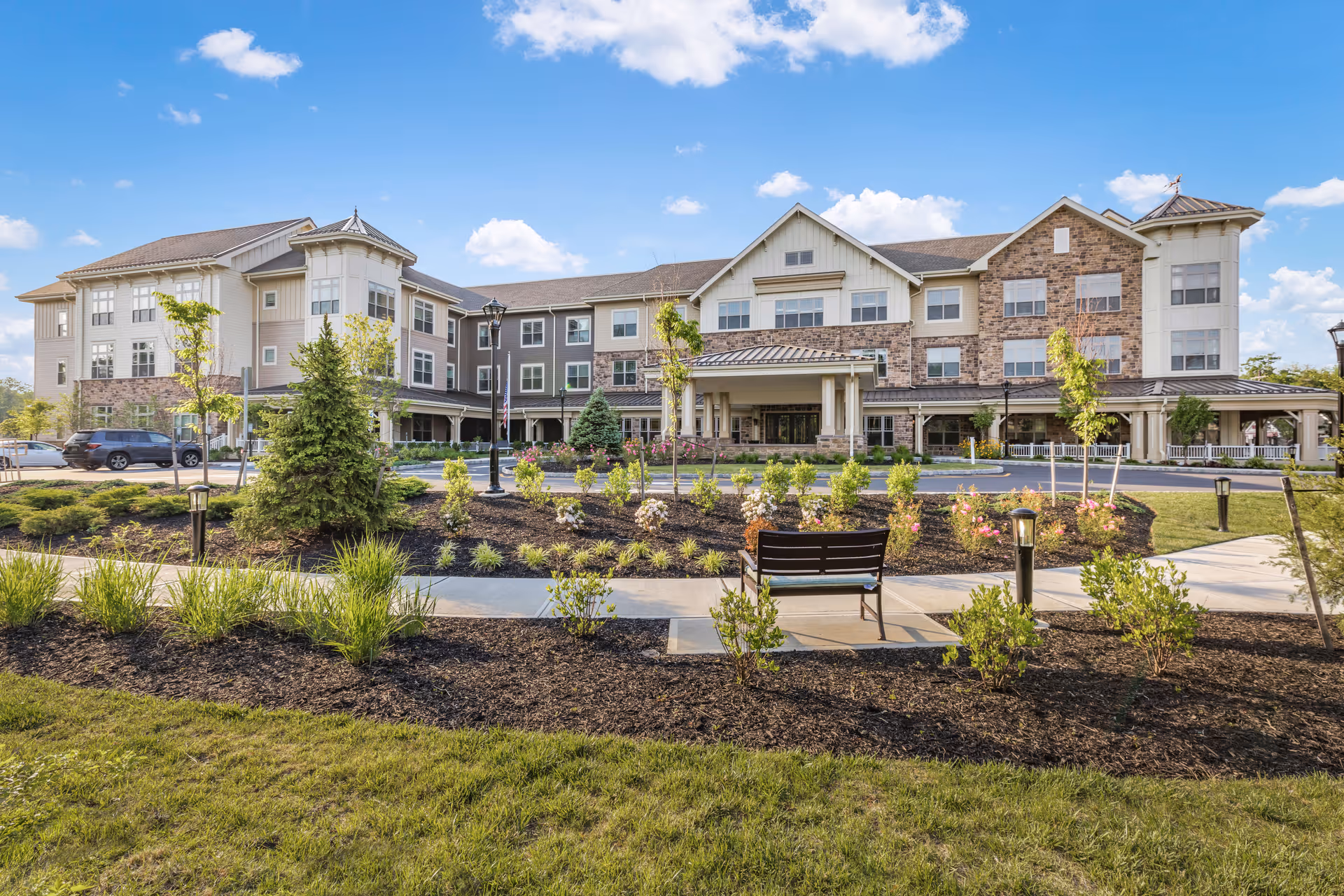 Sunrise of Shrewsbury front exterior of a multi-story senior living building with landscaped grounds.