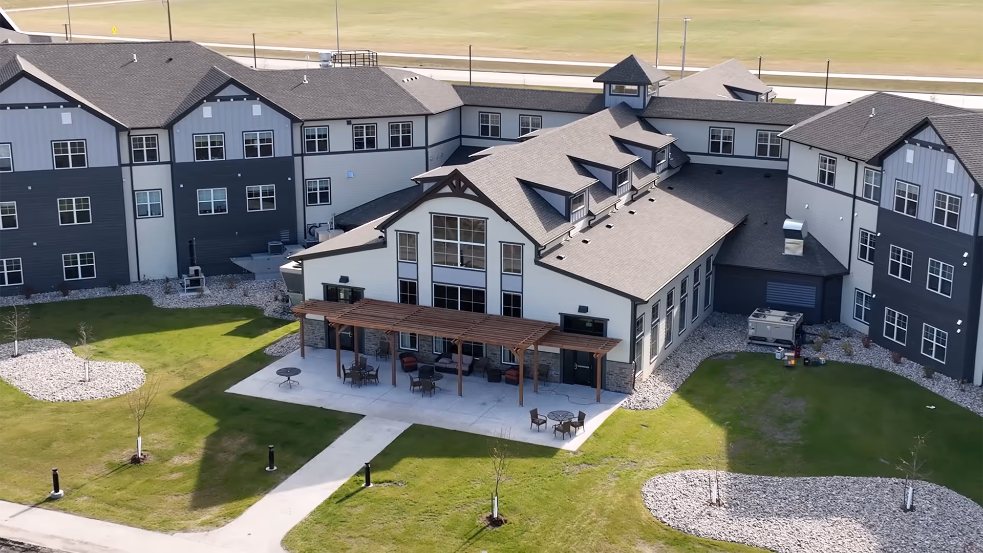Aerial view of Edgewood Grand Forks senior living campus with connected buildings and a central patio.