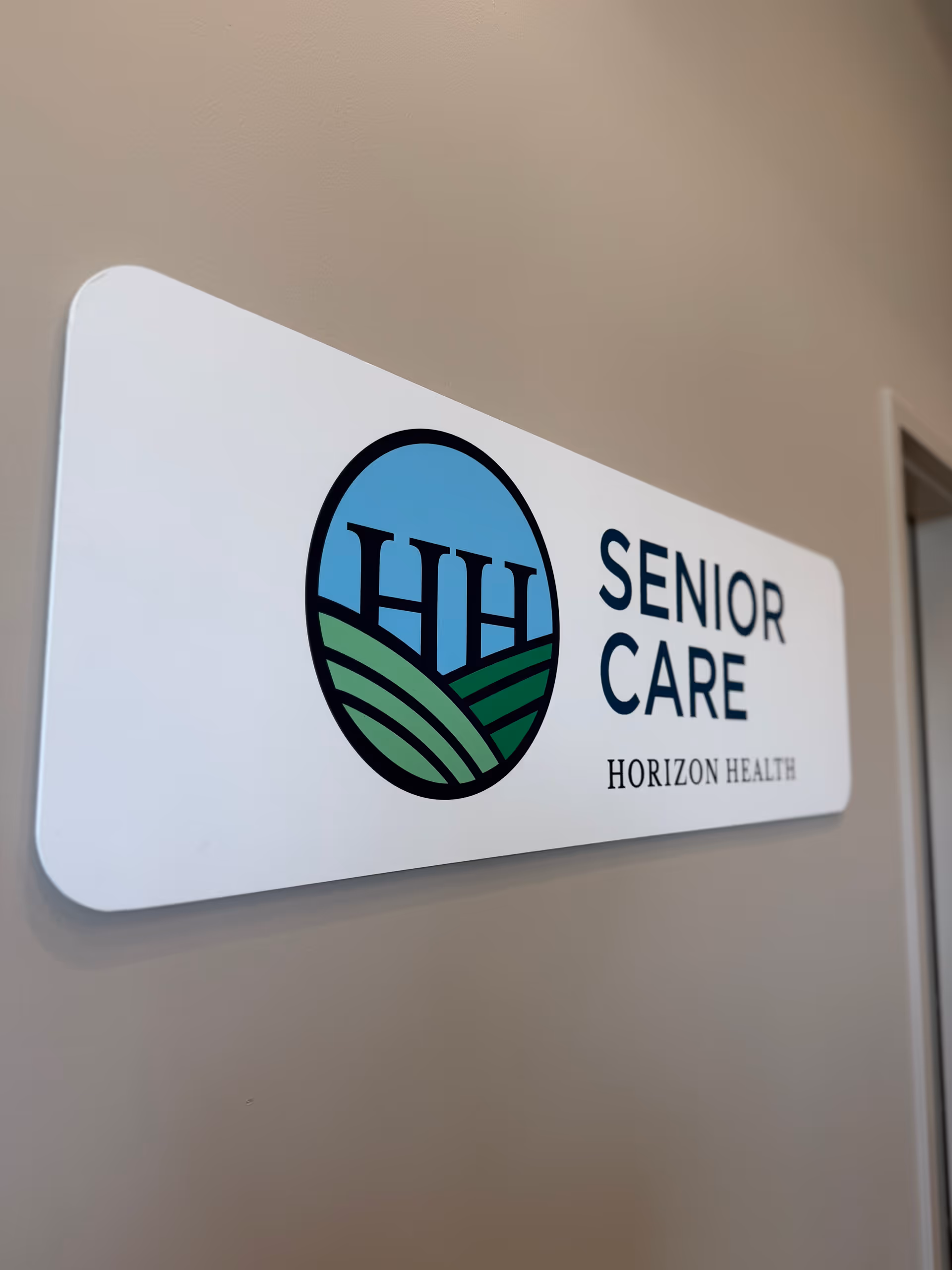 Indoor wall sign showing Senior Care and Horizon Health logo.