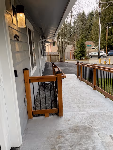 Exterior walkway of AVID Adult Family Home with railing and street view