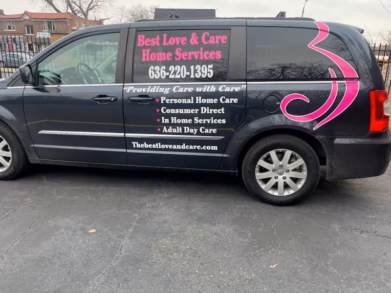 Dark van with pink lettering advertising Best Love and Care Home Services on its side.