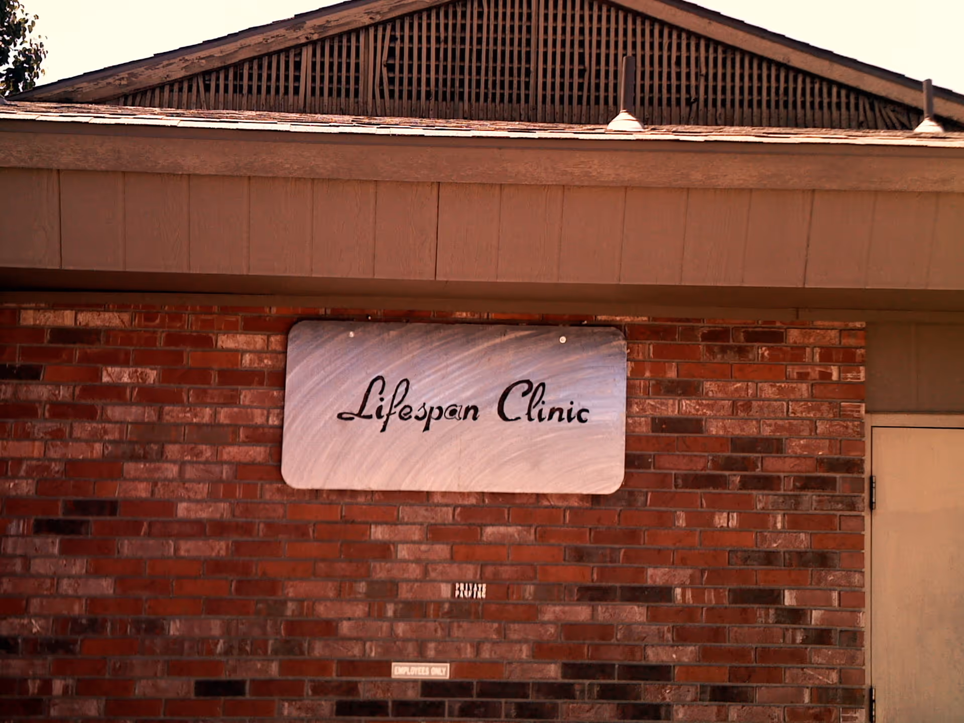 Brick exterior of a building with Lifespan Clinic sign on wall.