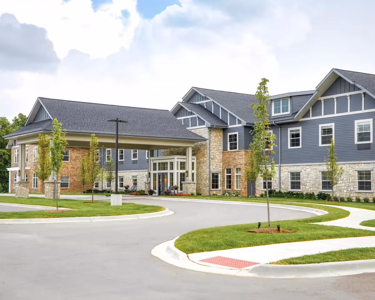 Exterior view of Provision Living at West Bloomfield showing the entrance and curved driveway