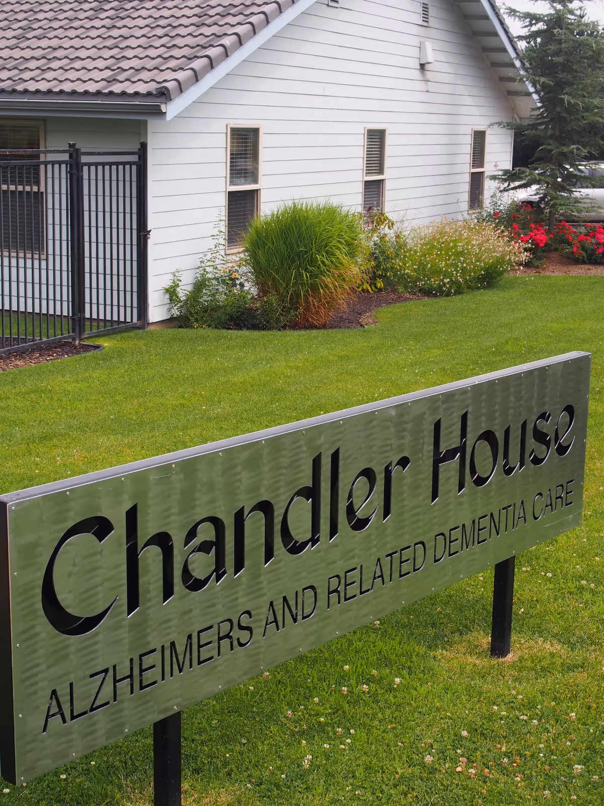 Exterior view of Chandler House with a large sign and manicured lawn.