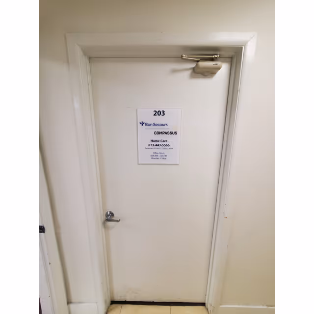 White interior hallway door labeled 203 with Bon Secours Compassus Home Care signage.