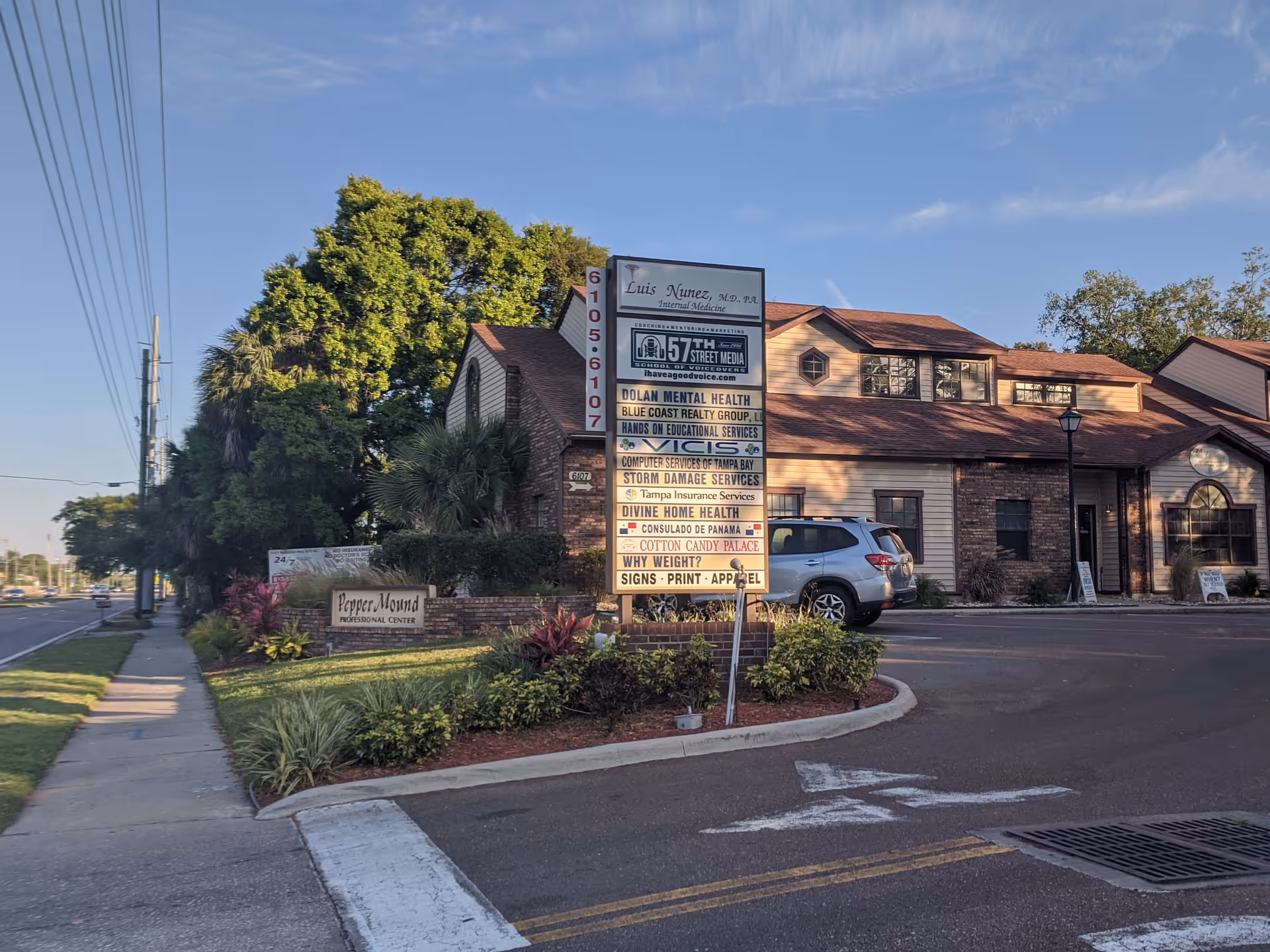 Exterior view of a building with a tall signboard for Divine Home Health Care, INC.
