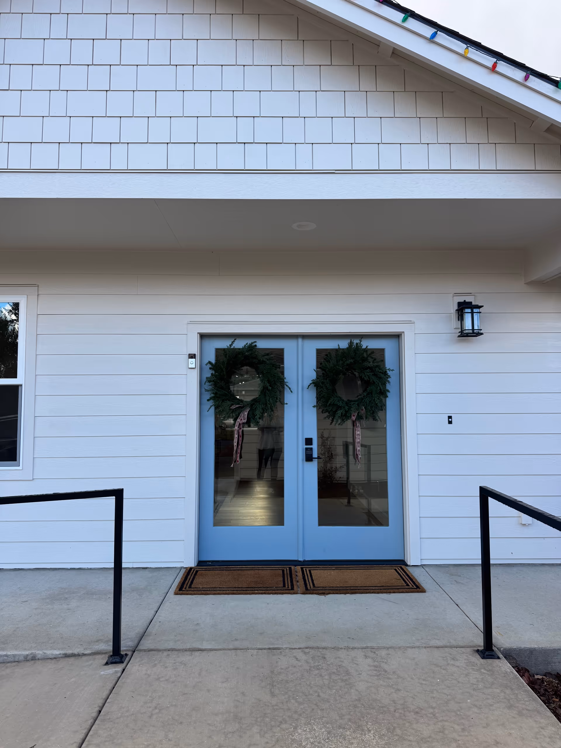 Double glass doors with wreaths at the Stillwater Care Home entrance.